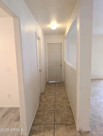 a view of a room with wooden floor and ceiling fan
