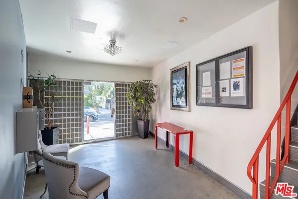 a hallway with furniture and a potted plant