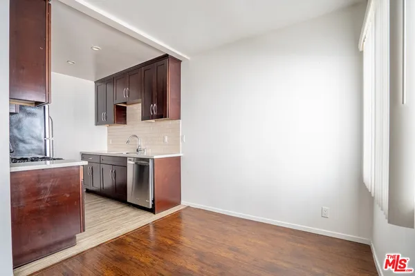 a kitchen with granite countertop a stove and a refrigerator