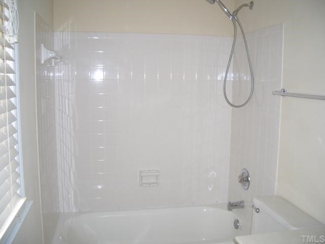 7301 Massachusetts Court Raleigh, NC 27615 - Photo 9 of 12 a bathroom with a bath tub with a shower