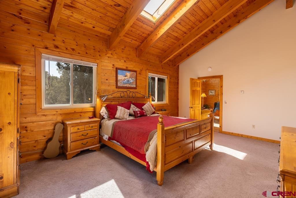 349 Mariposa Drive Durango, CO 81301 - Photo 14 of 34 a bedroom with a bed and a chandelier