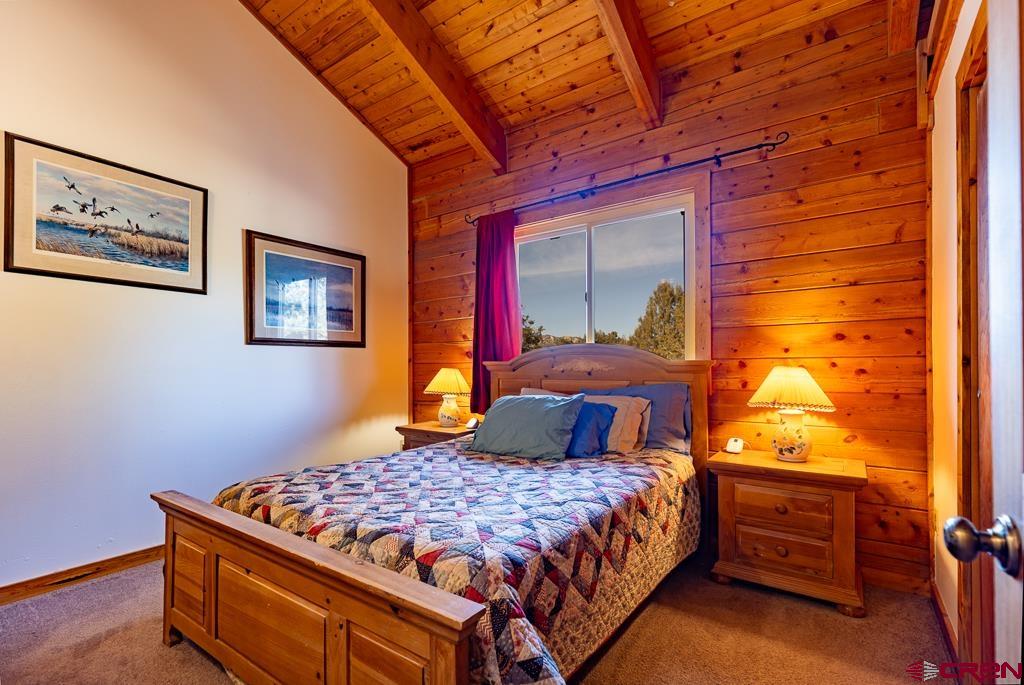 349 Mariposa Drive Durango, CO 81301 - Photo 16 of 34 a bedroom with a bed and wooden floor