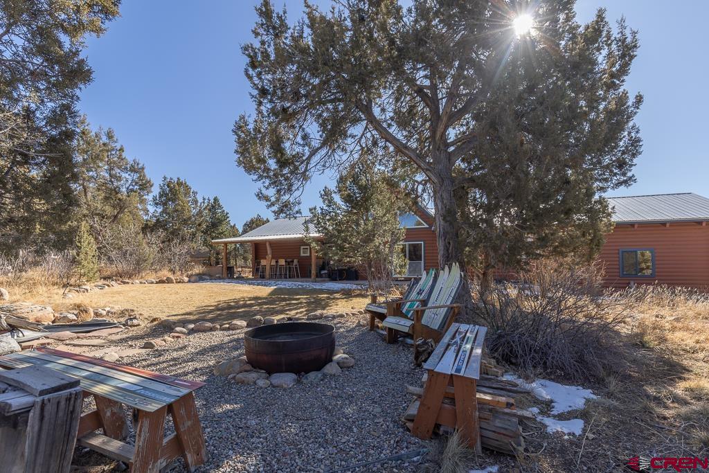 349 Mariposa Drive Durango, CO 81301 - Photo 26 of 34 a view of a backyard with table and chairs under an umbrella