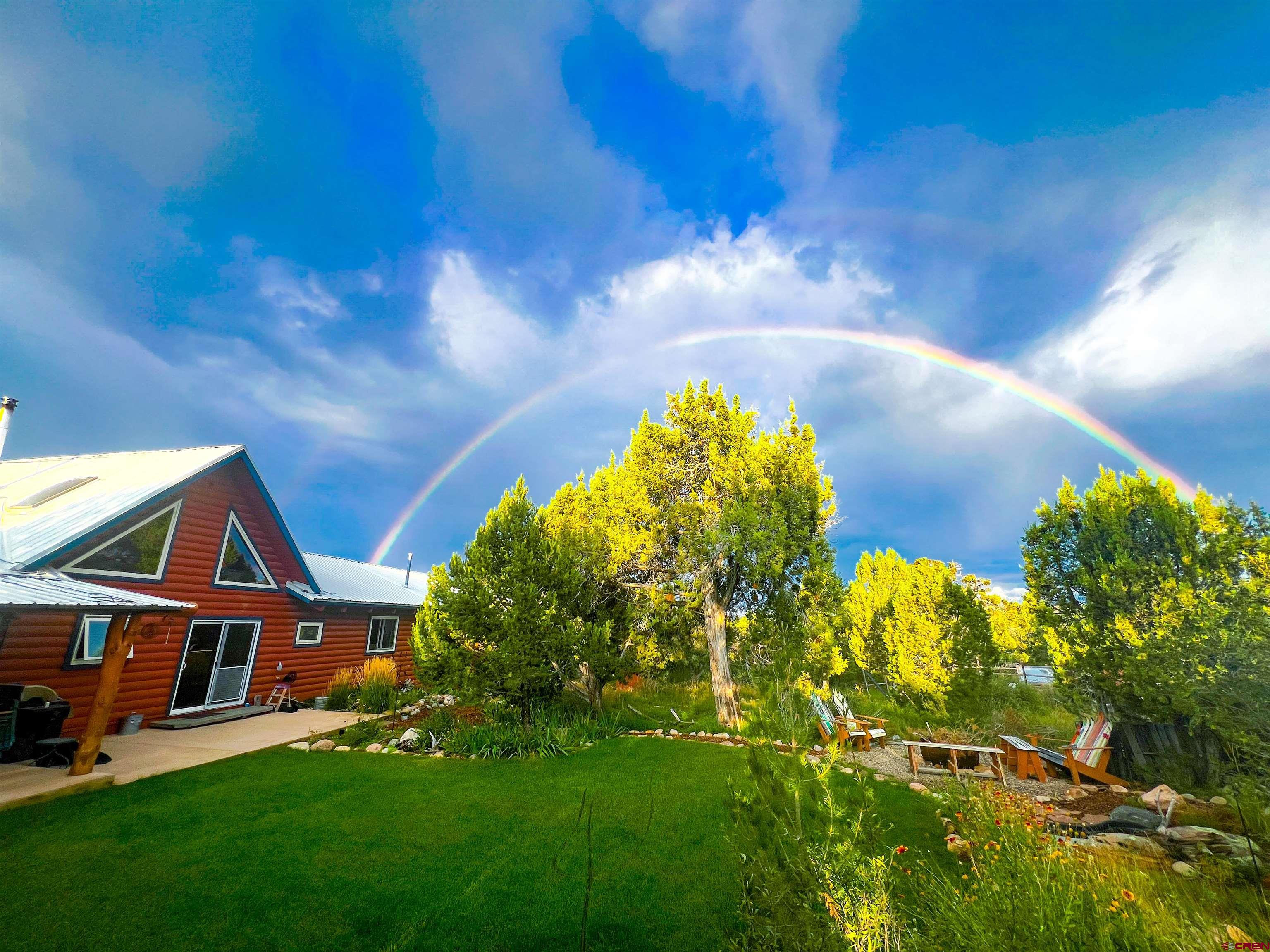 349 Mariposa Drive Durango, CO 81301 - Photo 3 of 34 a front view of house with yard and trees in the background