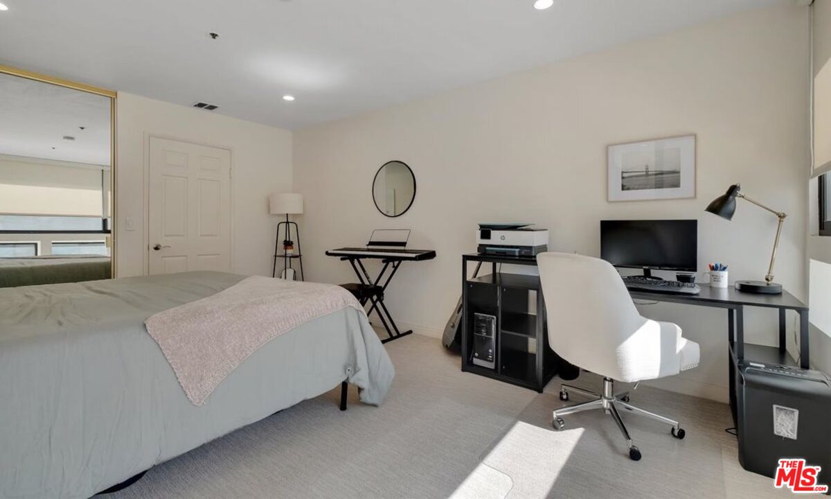 121 South Hope Street, Unit 313 Los Angeles, CA 90012 - Photo 15 of 35 a bedroom with a bed a desk and chair