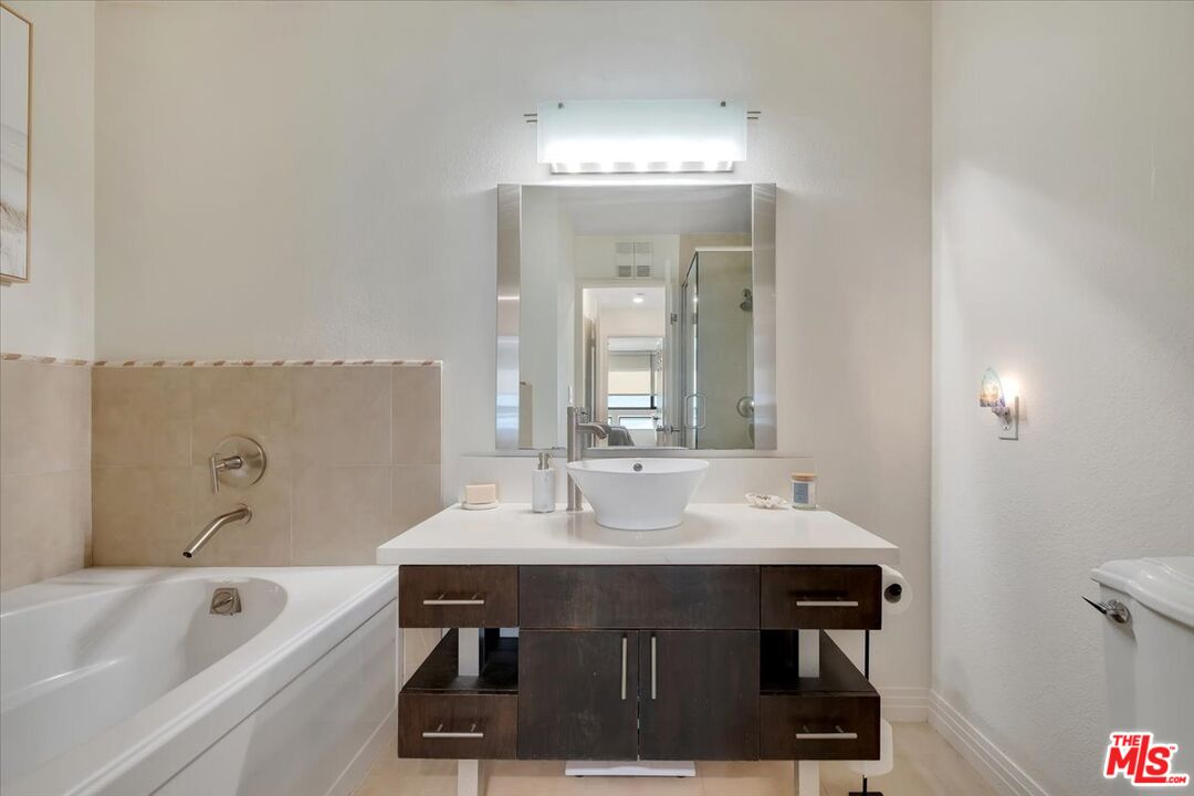 121 South Hope Street, Unit 313 Los Angeles, CA 90012 - Photo 17 of 35 a bathroom with a sink and a mirror