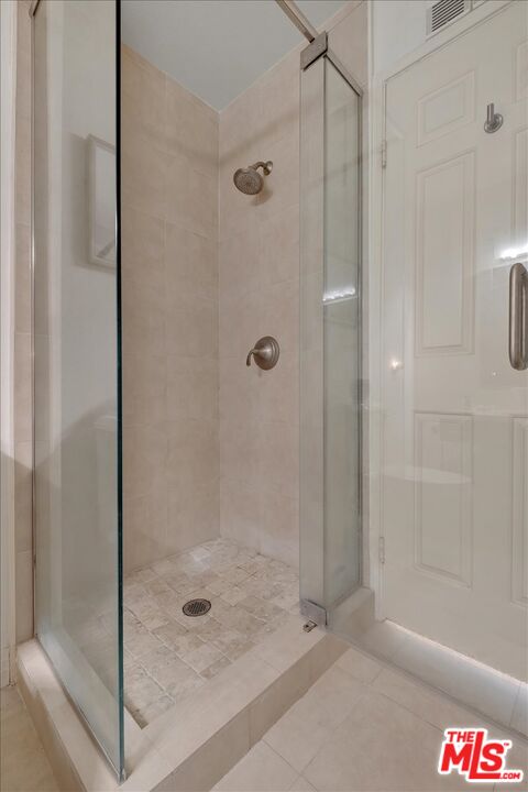 121 South Hope Street, Unit 313 Los Angeles, CA 90012 - Photo 19 of 35 a bathroom with a glass shower door