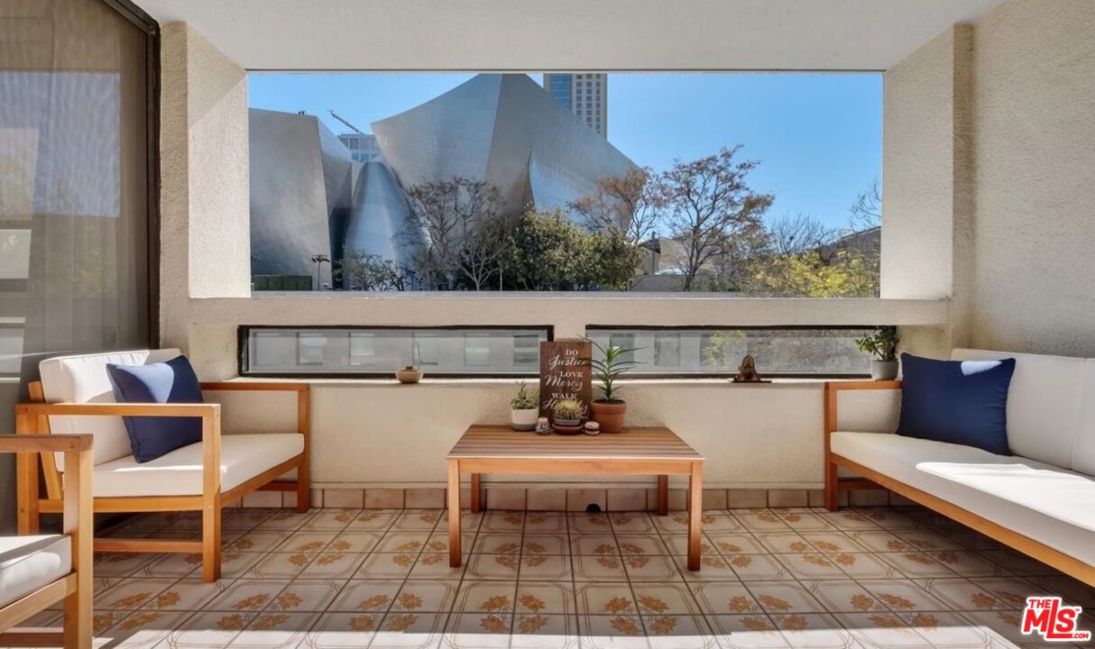 121 South Hope Street, Unit 313 Los Angeles, CA 90012 - Photo 2 of 35 a living room with a couch and a table