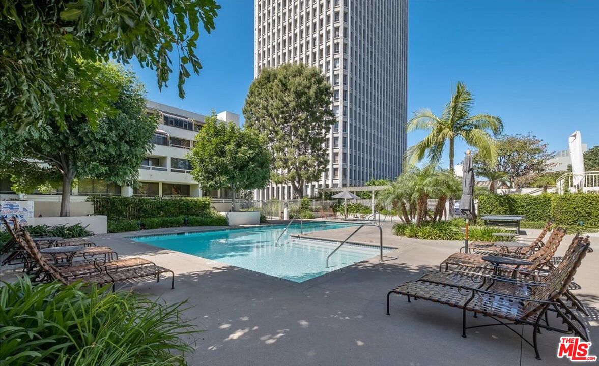 121 South Hope Street, Unit 313 Los Angeles, CA 90012 - Photo 23 of 35 a view of a patio with a table and chairs under an umbrella