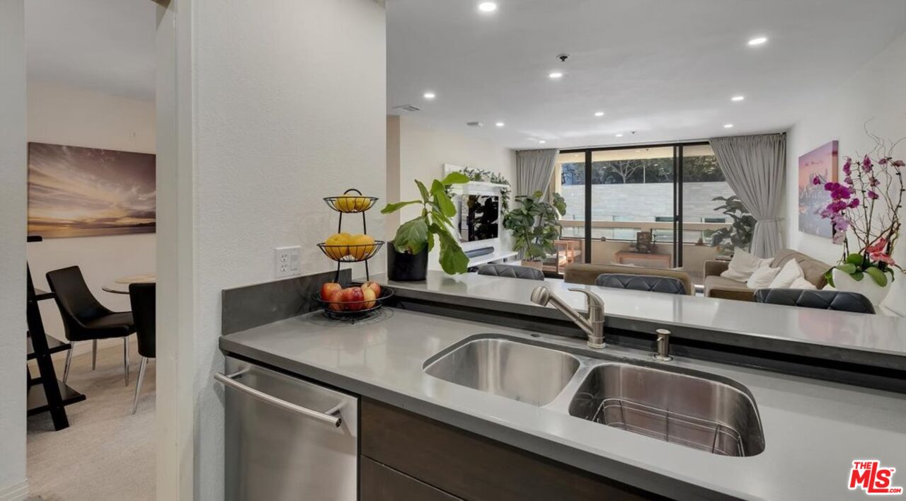 121 South Hope Street, Unit 313 Los Angeles, CA 90012 - Photo 7 of 35 a kitchen with a sink and a refrigerator