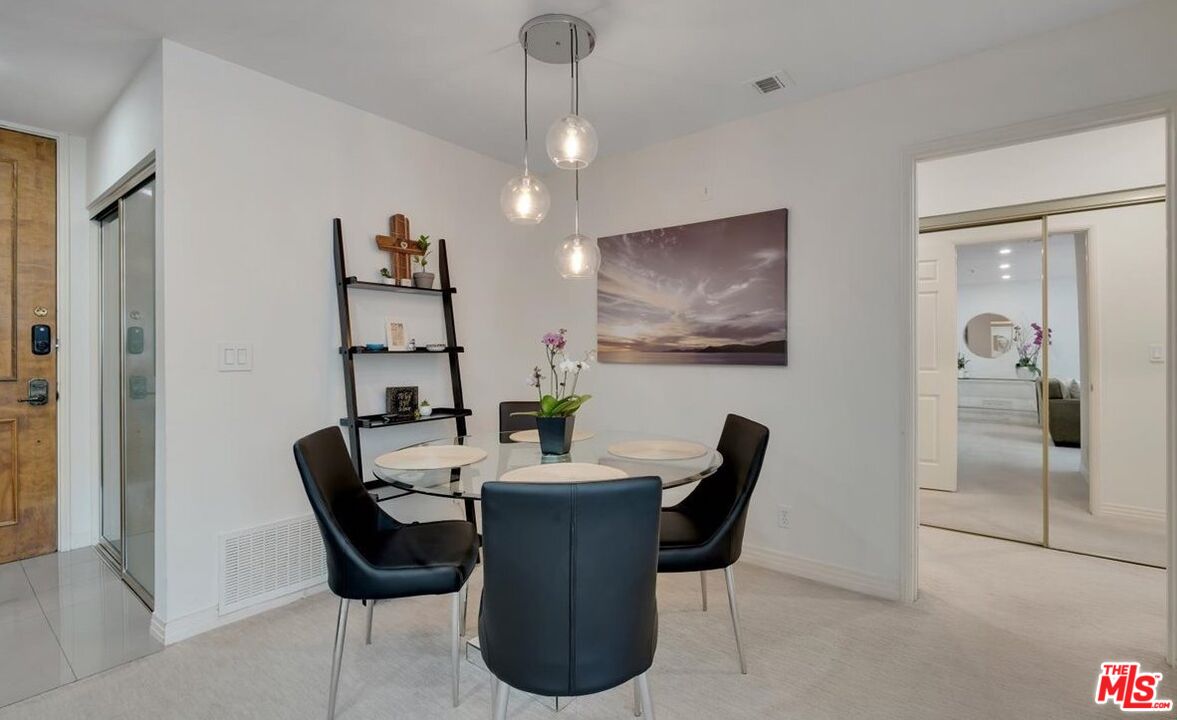 121 South Hope Street, Unit 313 Los Angeles, CA 90012 - Photo 8 of 35 a view of a dining room with furniture