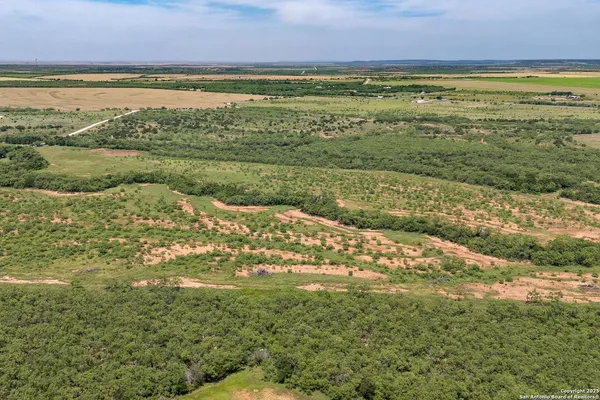 a view of a field with an ocean view