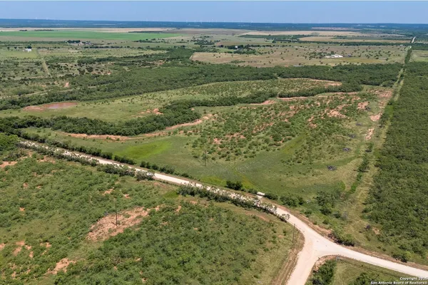 a view of a field with an ocean view