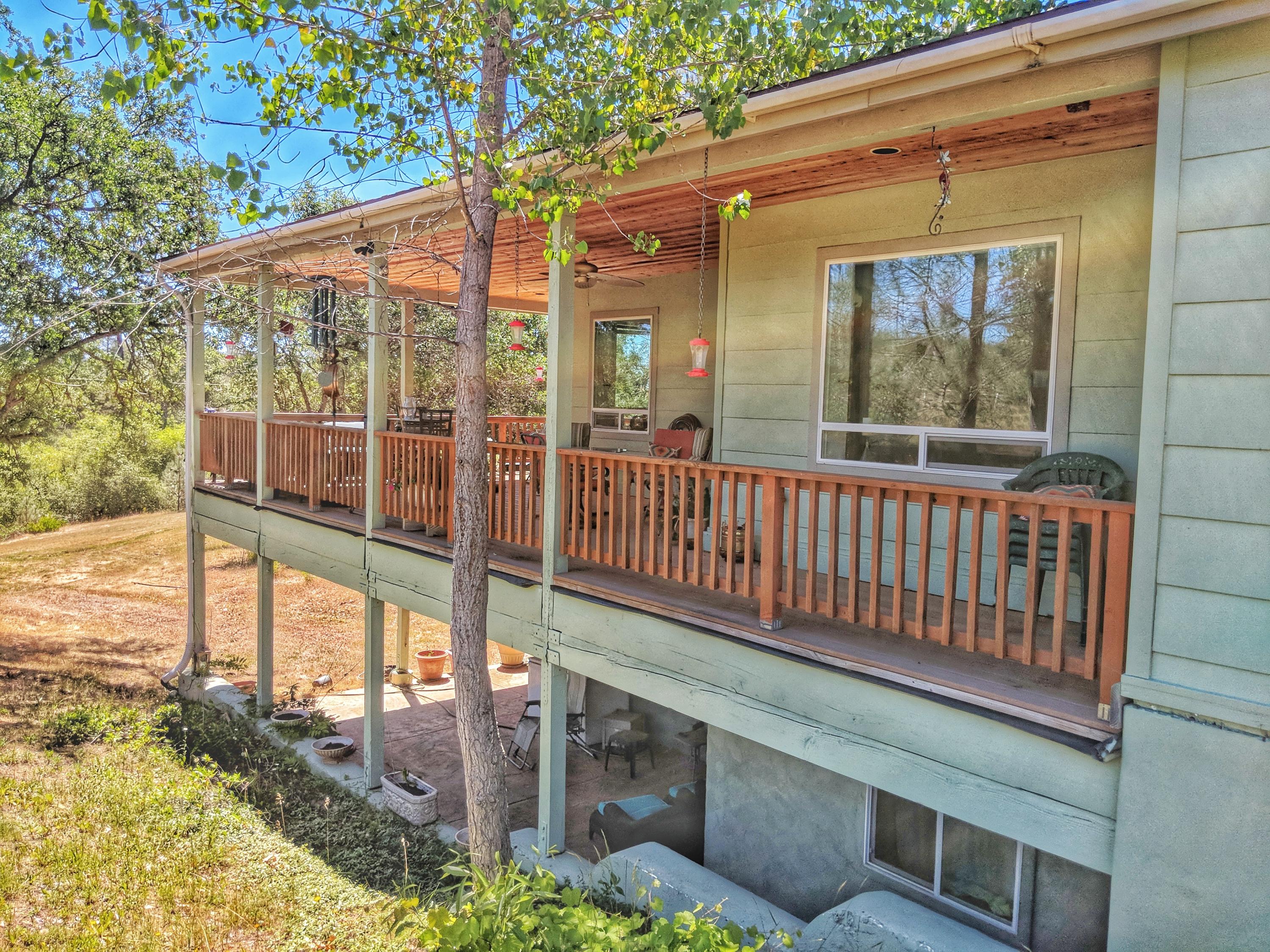 6818 Rector Creek Road Igo, CA 96047 - Photo 23 of 34 a view of a porch with a floor to ceiling window and wooden fence