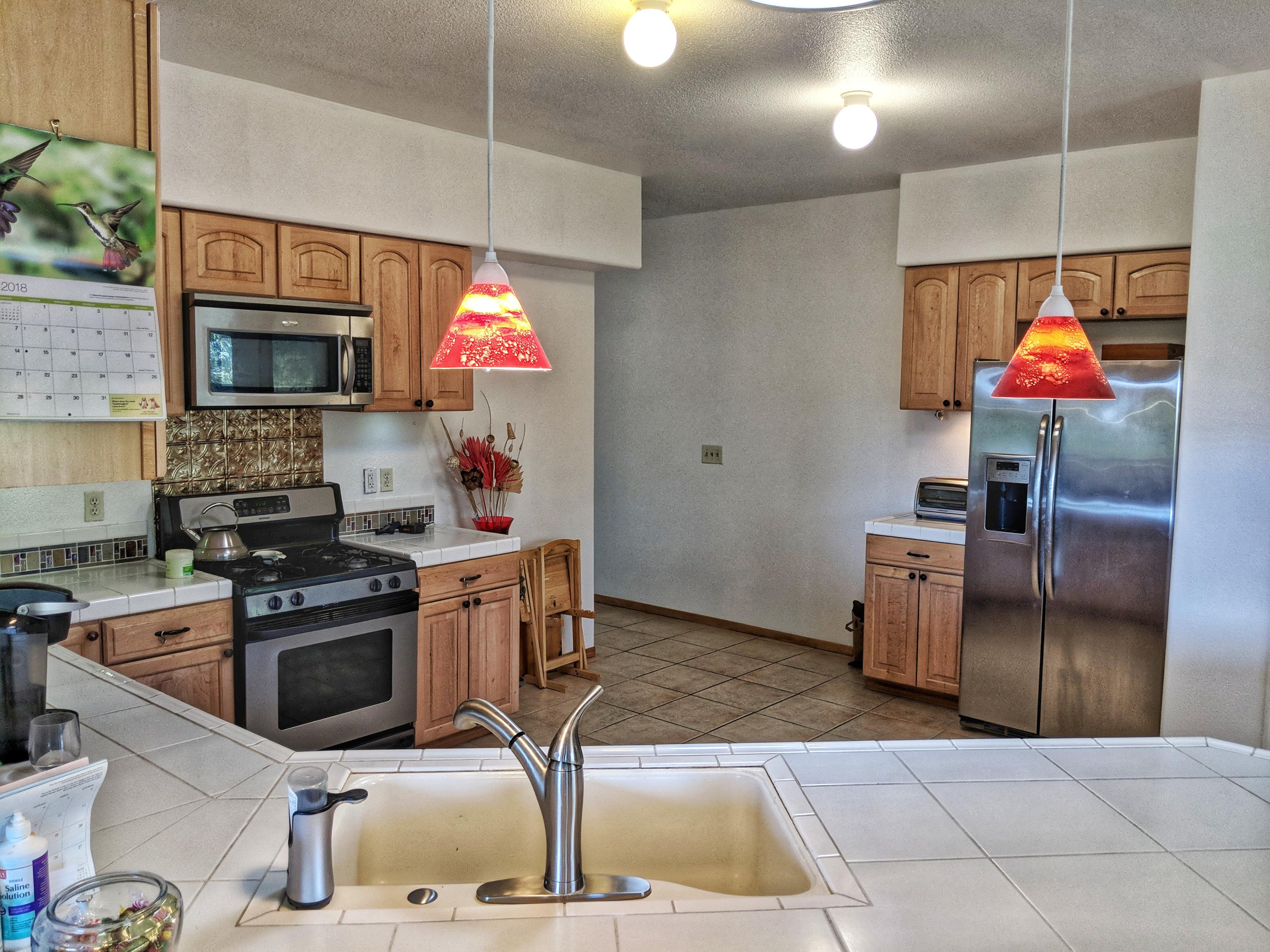6818 Rector Creek Road Igo, CA 96047 - Photo 6 of 34 a kitchen with stainless steel appliances granite countertop a stove a sink and a microwave