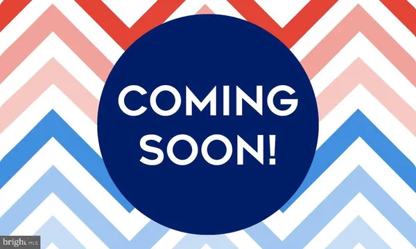 a blue sign that is sitting on a wall