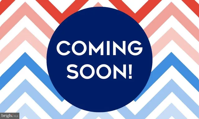 a blue sign that is sitting on a wall