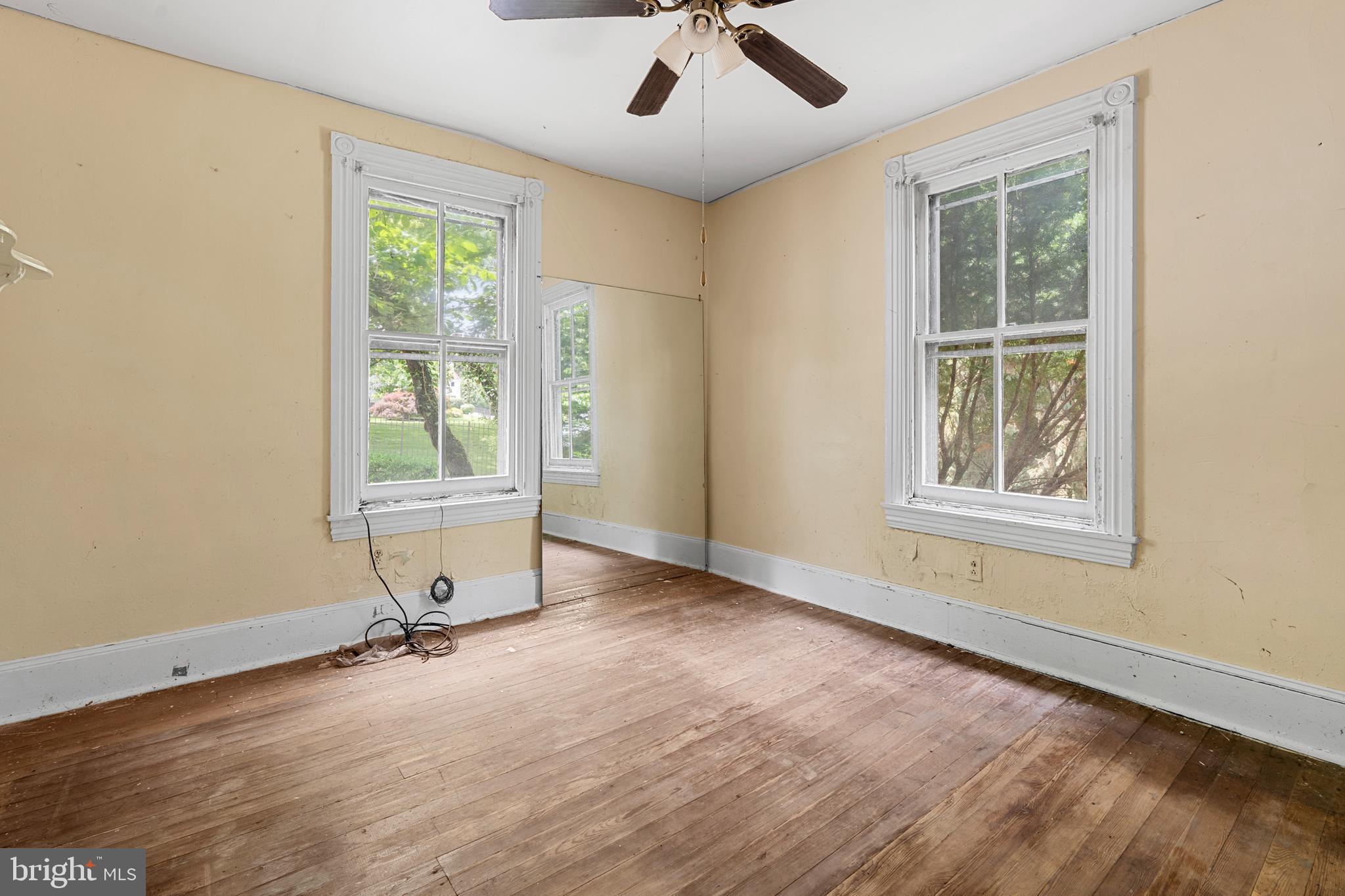 527 Berwyn Baptist Road Devon, PA 19333 - Photo 7 of 20 a view of an empty room with a window and wooden floor