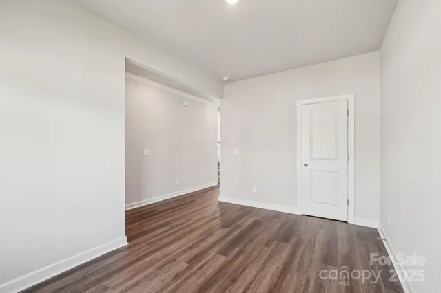 a view of an empty room and wooden floor