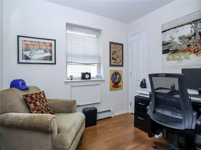 a living room with furniture and painting on the wall