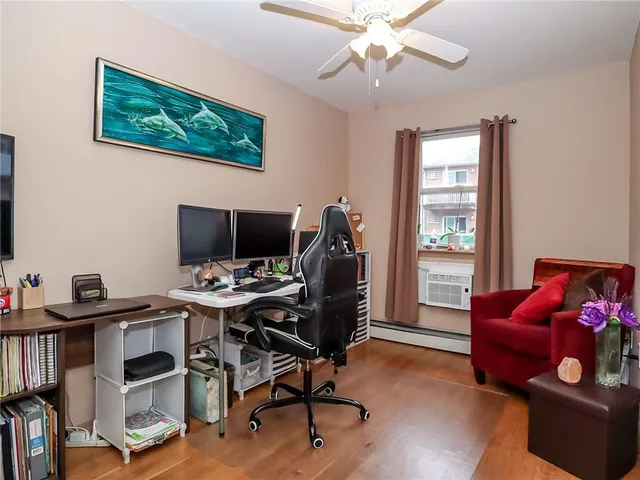 a view of a workspace with furniture and a window