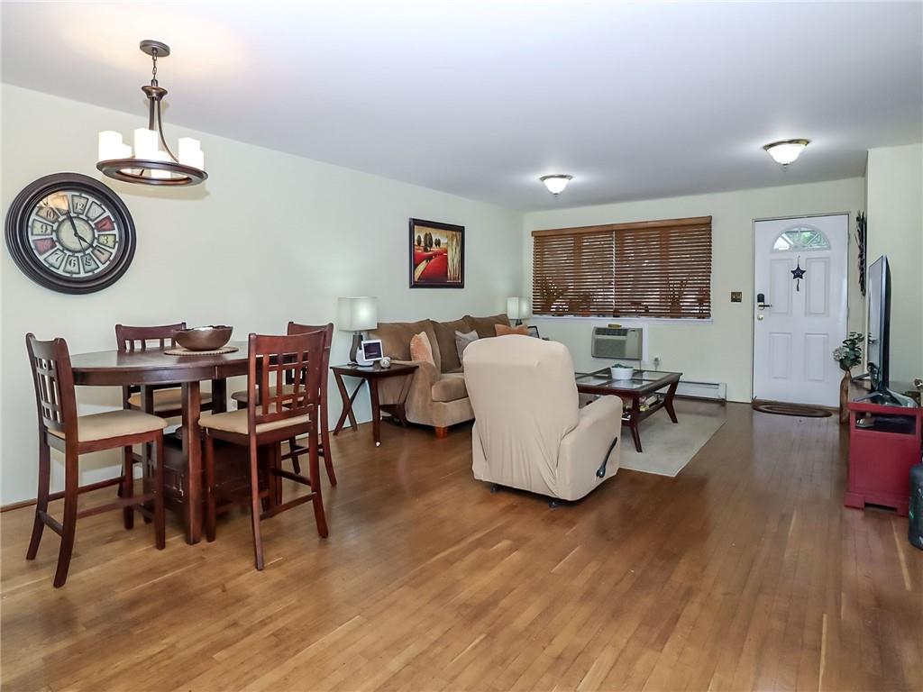 2312 Stuart Street, Unit 2L Brooklyn, NY 11229 - Photo 5 of 24 a view of a dining room with furniture a chandelier and wooden floor