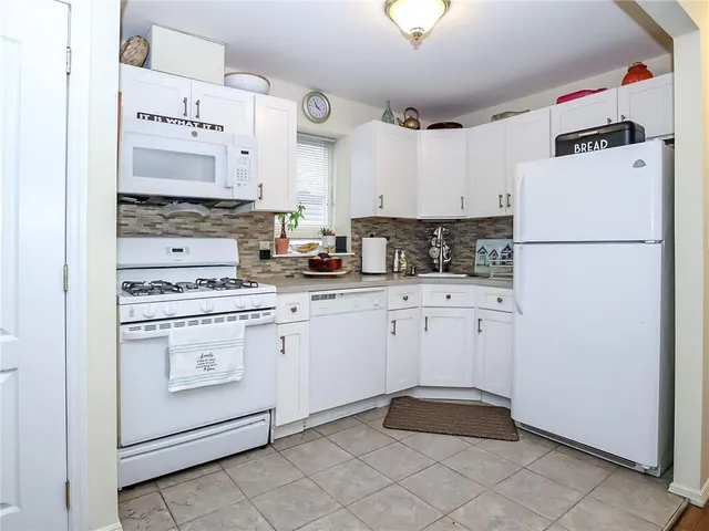 a kitchen with cabinets and white appliances
