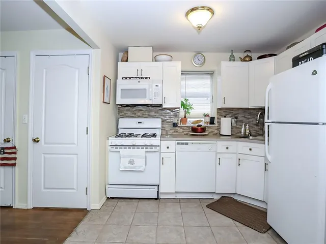 a kitchen with stainless steel appliances a refrigerator sink and cabinets