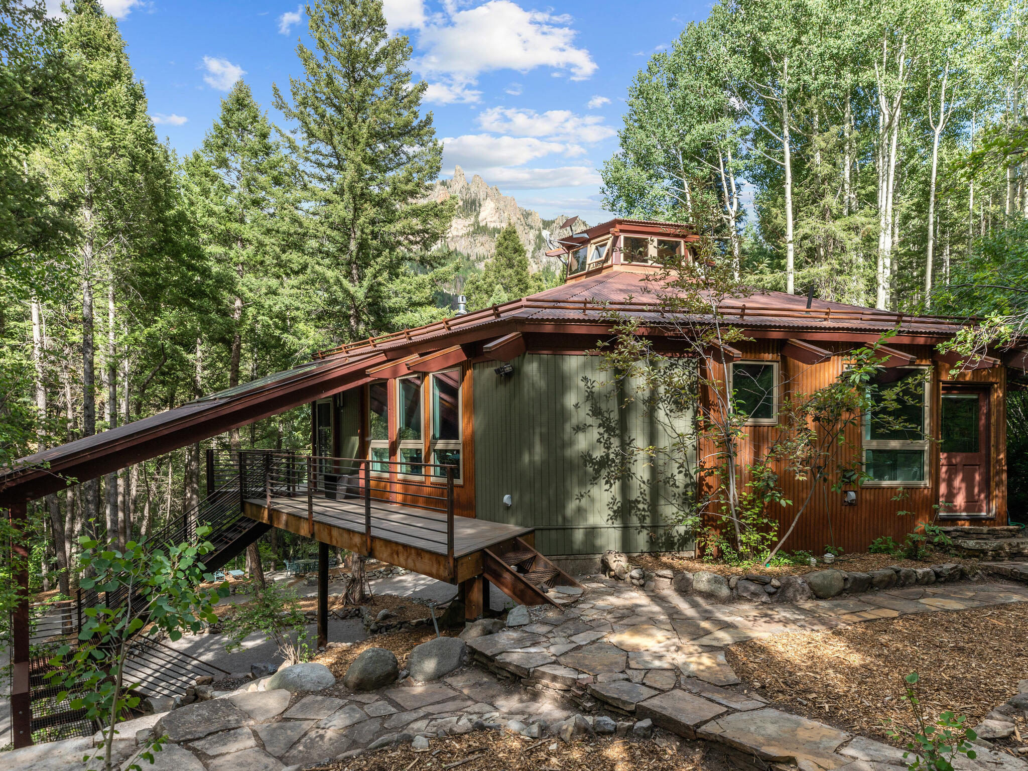 226 Lake Fork Junction Road Ophir, CO 81426 - Photo 4 of 31 a view of a wooden house with a yard