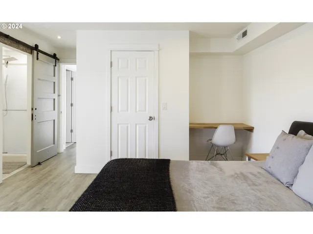a bedroom with a bed and a black countertop