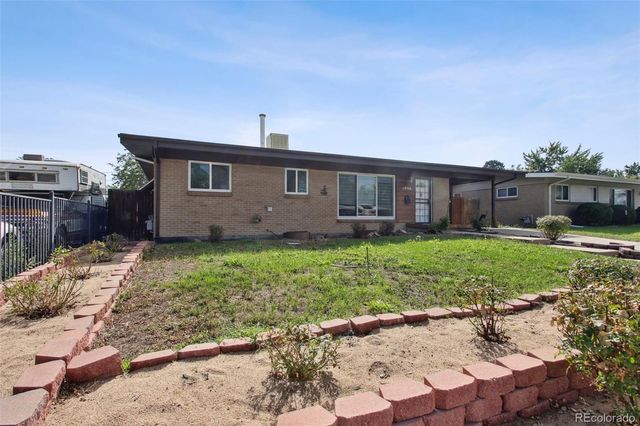 a front view of house with yard and green space