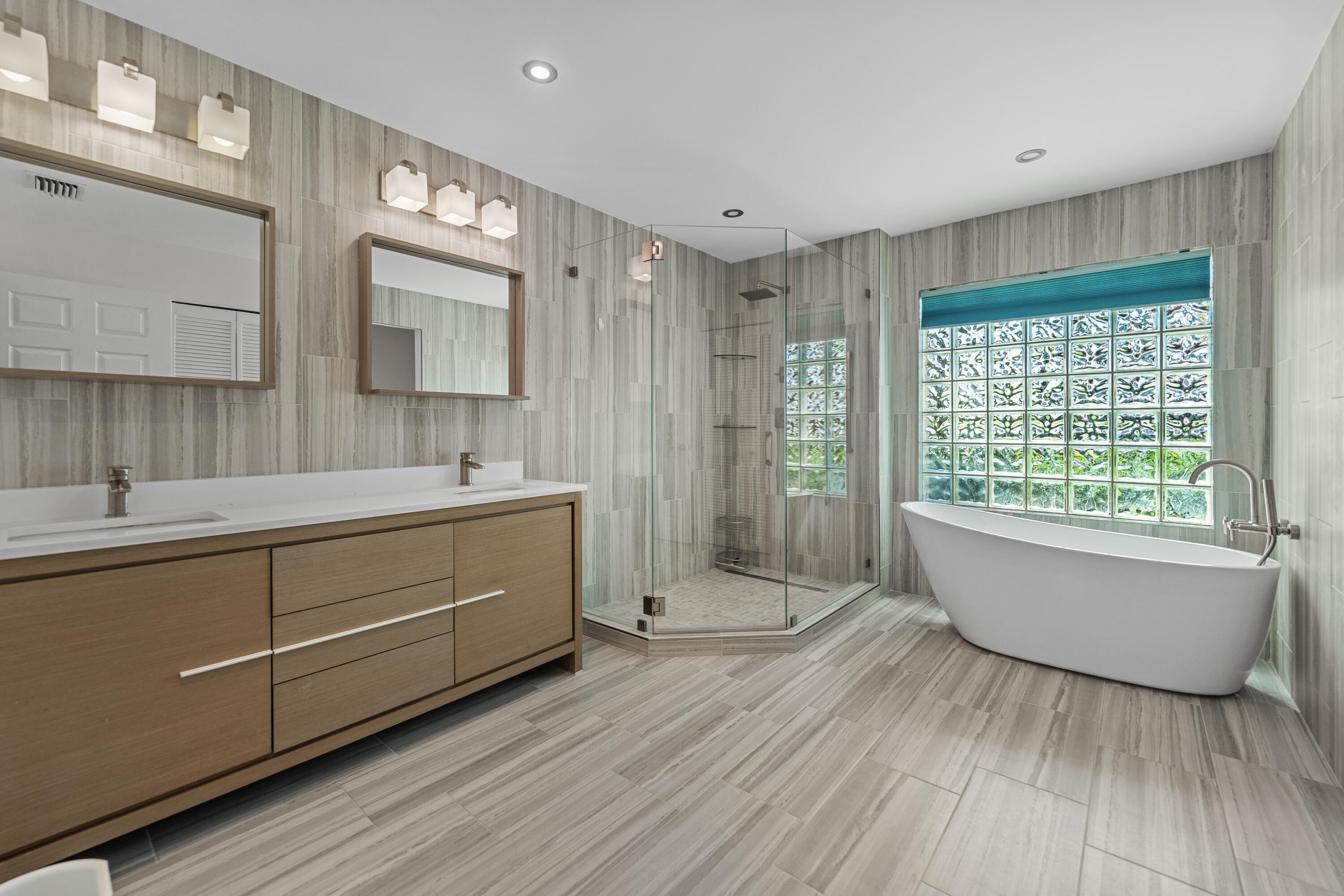 10648 Maple Chase Drive Boca Raton, FL 33498 - Photo 20 of 52 a bathroom with a double vanity sink a mirror and a bathtub