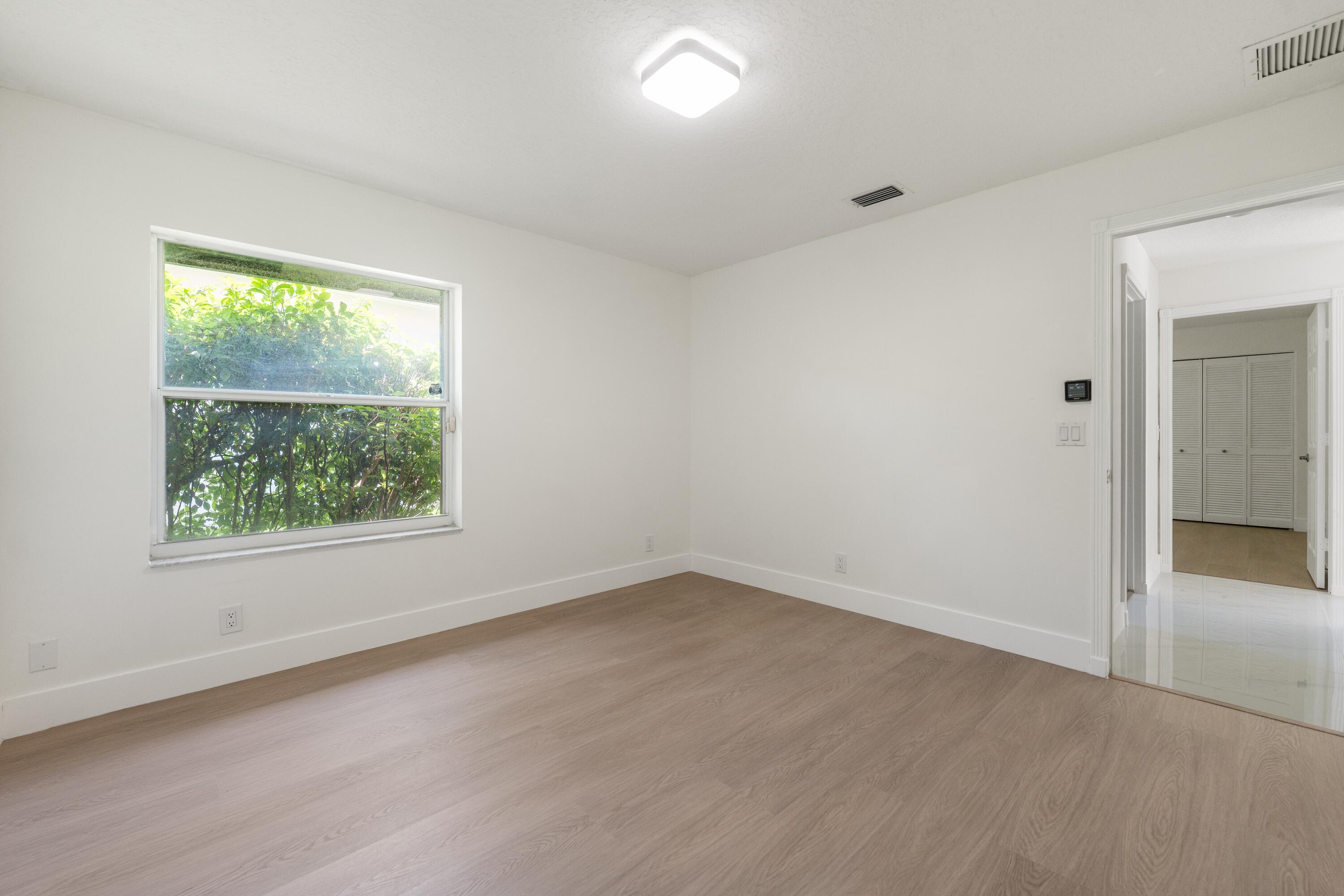 10648 Maple Chase Drive Boca Raton, FL 33498 - Photo 24 of 52 an empty room with a window