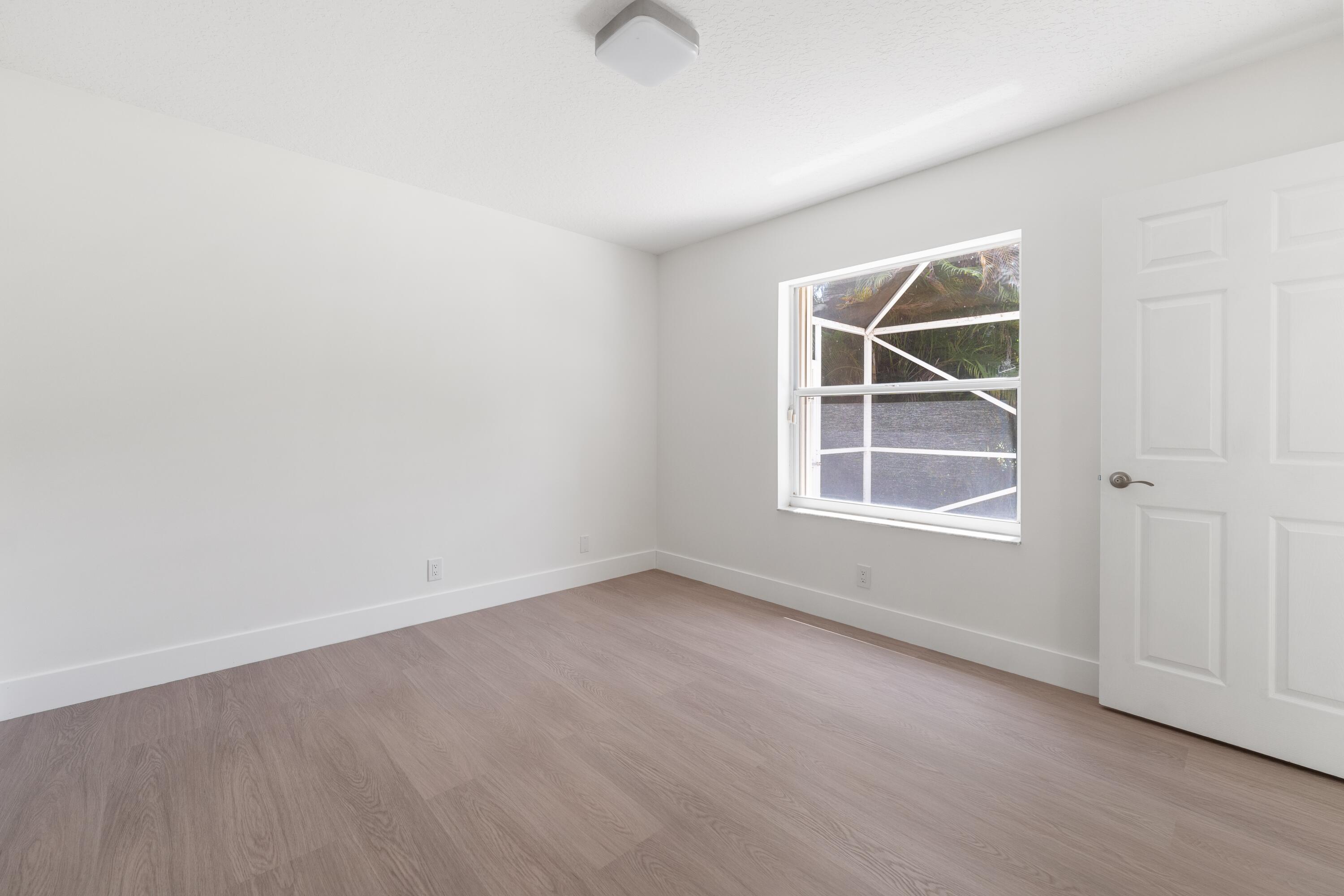 10648 Maple Chase Drive Boca Raton, FL 33498 - Photo 25 of 52 an empty room with windows