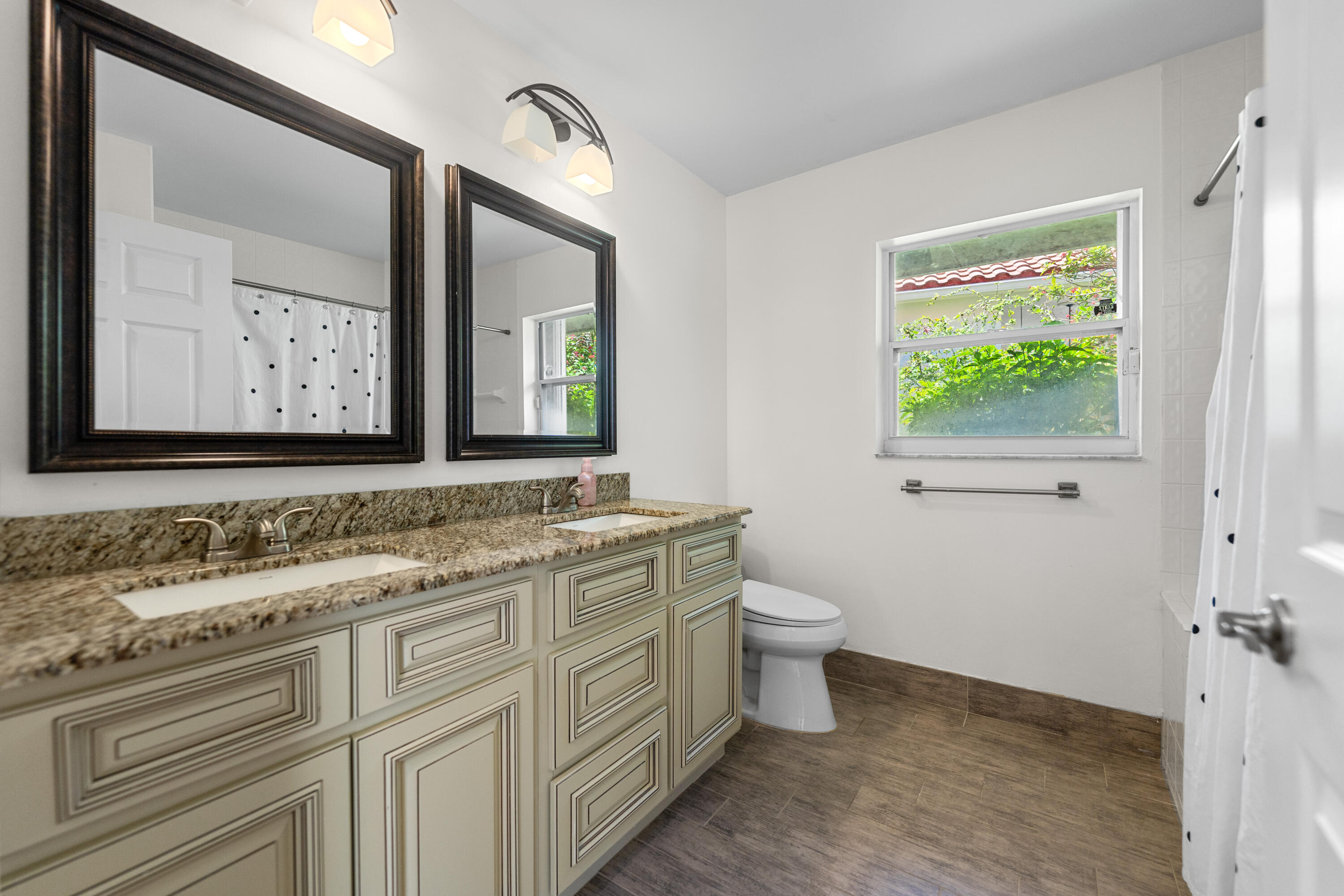 10648 Maple Chase Drive Boca Raton, FL 33498 - Photo 28 of 52 a bathroom with a toilet sink and mirror