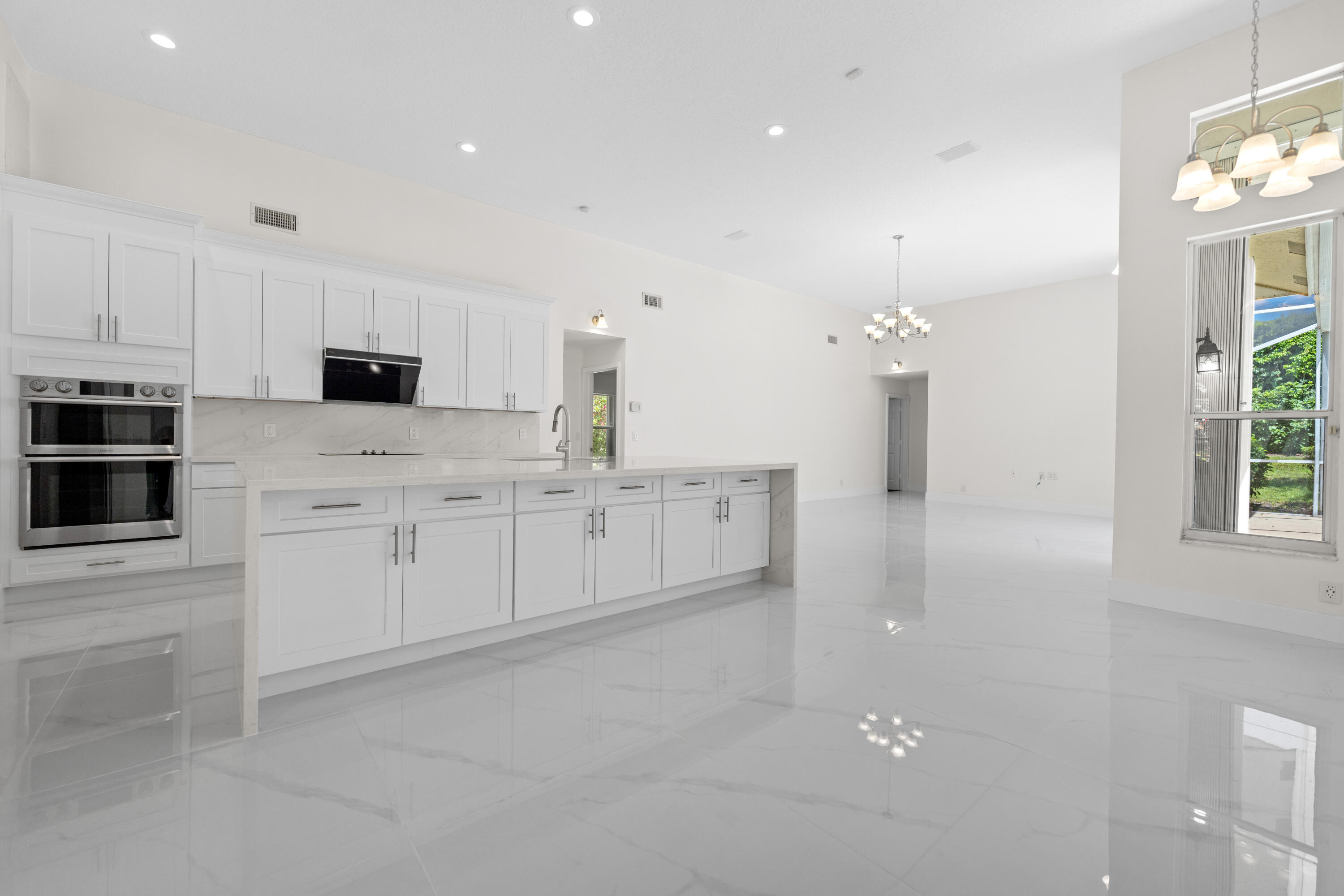 10648 Maple Chase Drive Boca Raton, FL 33498 - Photo 3 of 52 a kitchen with white cabinets and sink