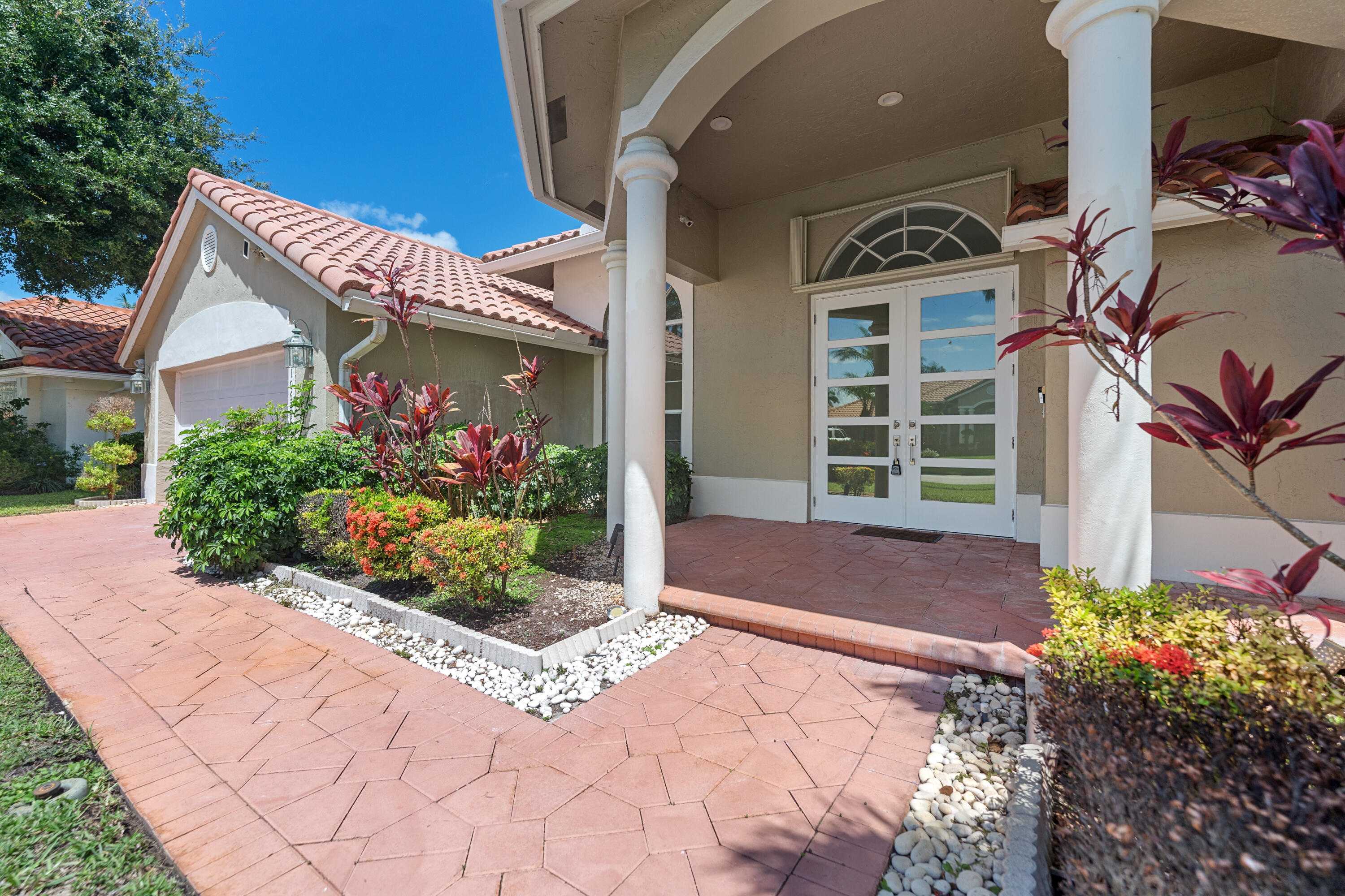 10648 Maple Chase Drive Boca Raton, FL 33498 - Photo 37 of 52 a front view of a house with a yard