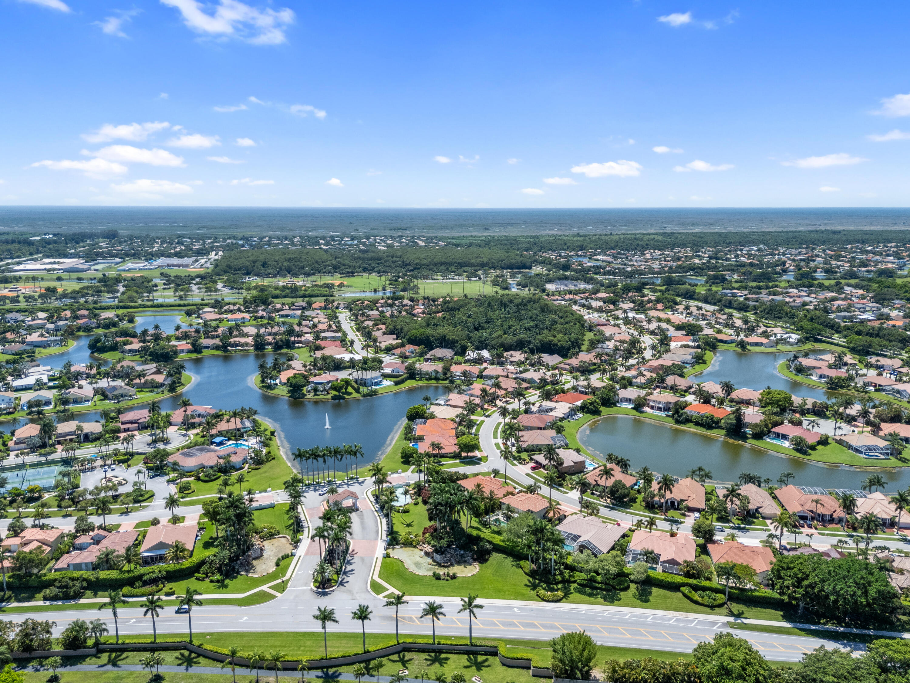 10648 Maple Chase Drive Boca Raton, FL 33498 - Photo 50 of 52 an aerial view of a city with lots of residential buildings and ocean view in back
