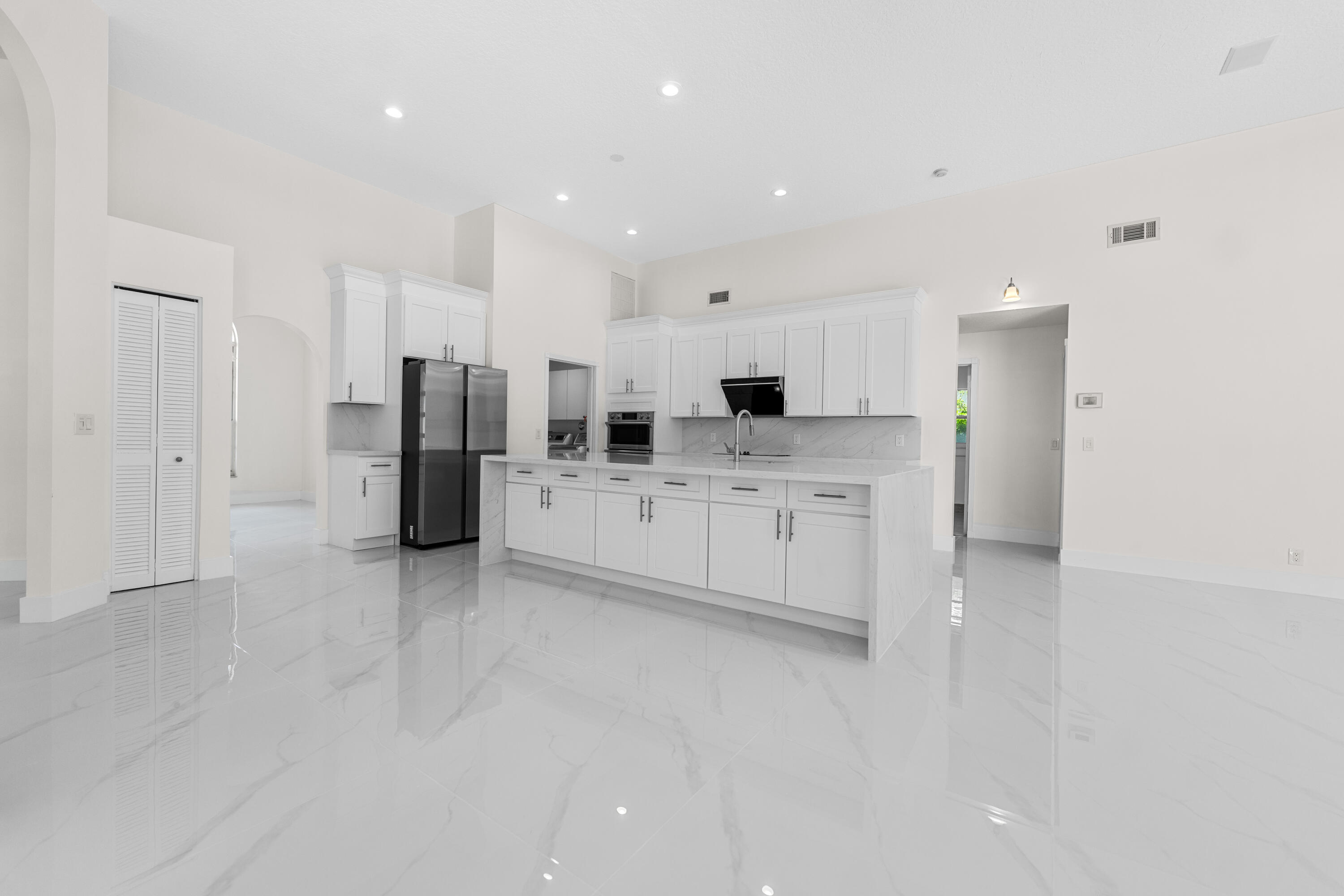 10648 Maple Chase Drive Boca Raton, FL 33498 - Photo 6 of 52 a large white kitchen with a sink and refrigerator