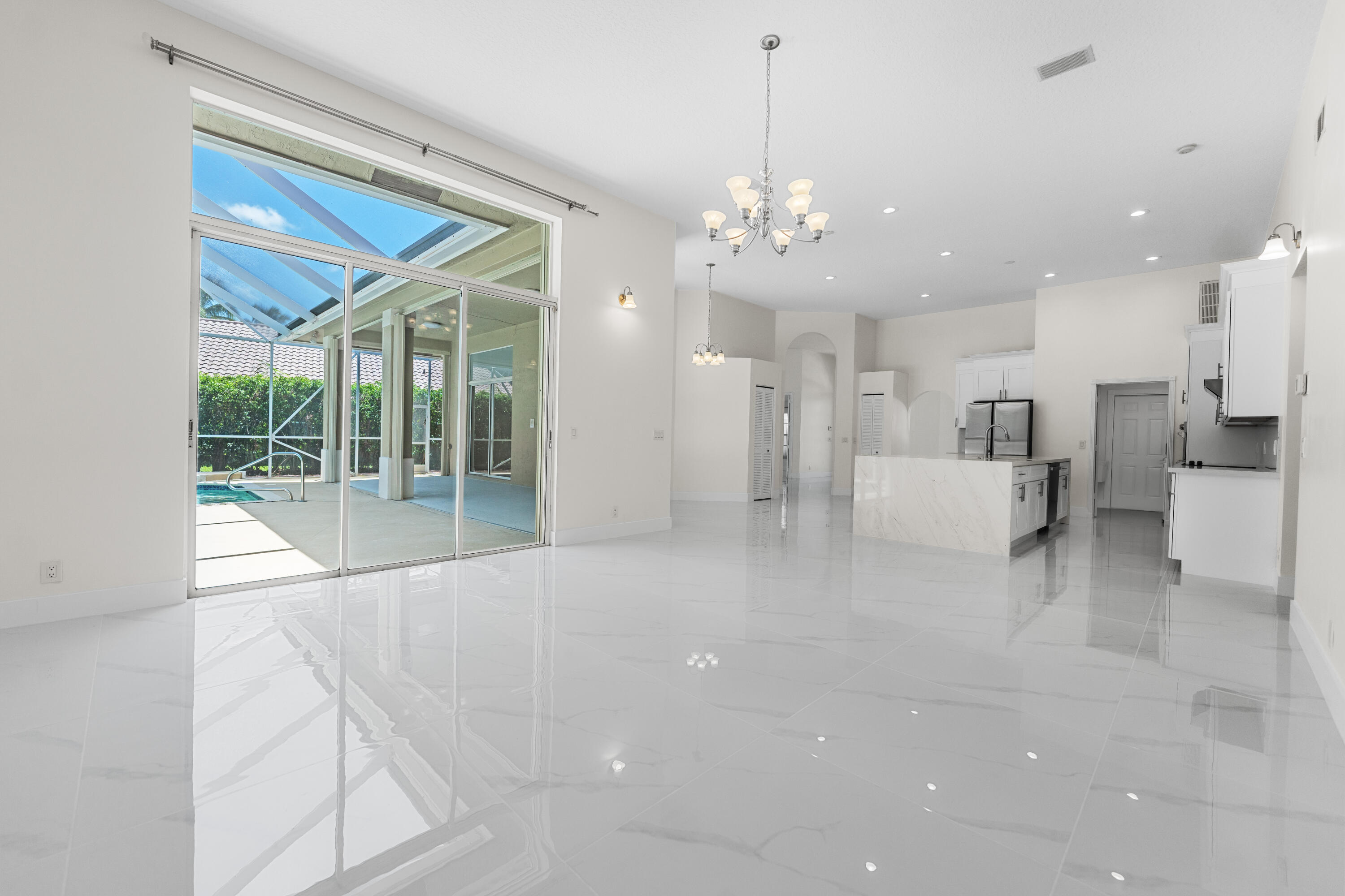 10648 Maple Chase Drive Boca Raton, FL 33498 - Photo 9 of 52 a view of a livingroom with a furniture wooden floor and a chandelier