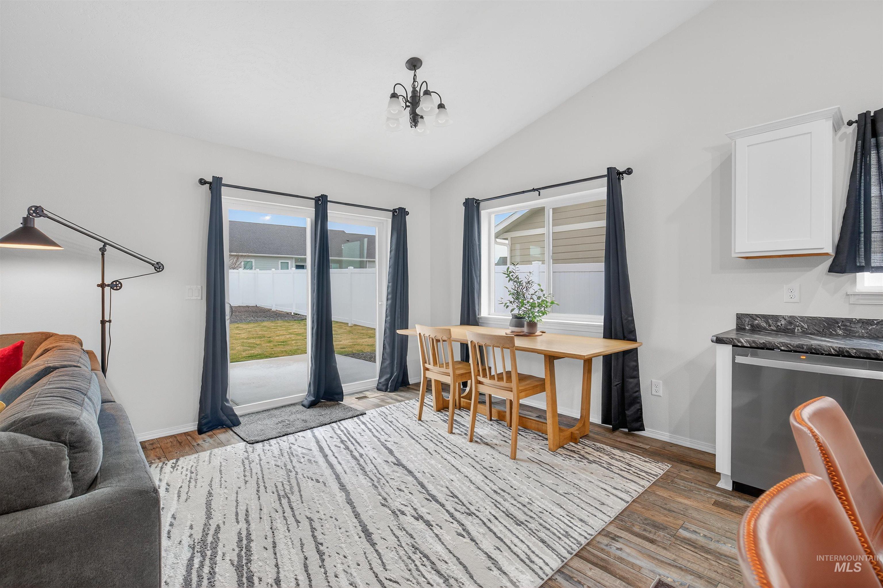 1432 Horizon Court Lewiston, ID 83501 - Photo 13 of 26 Dining room featuring vaulted ceiling, dark wood-type flooring, and a chandelier