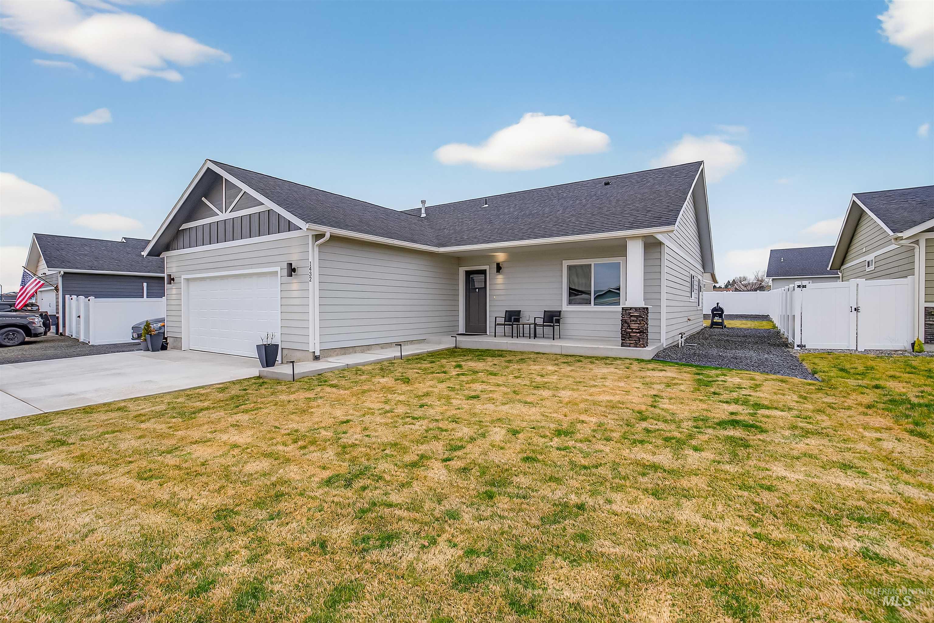 1432 Horizon Court Lewiston, ID 83501 - Photo 2 of 26 View of front of house with a gate, board and batten siding, driveway, an attached garage, and roof with shingles