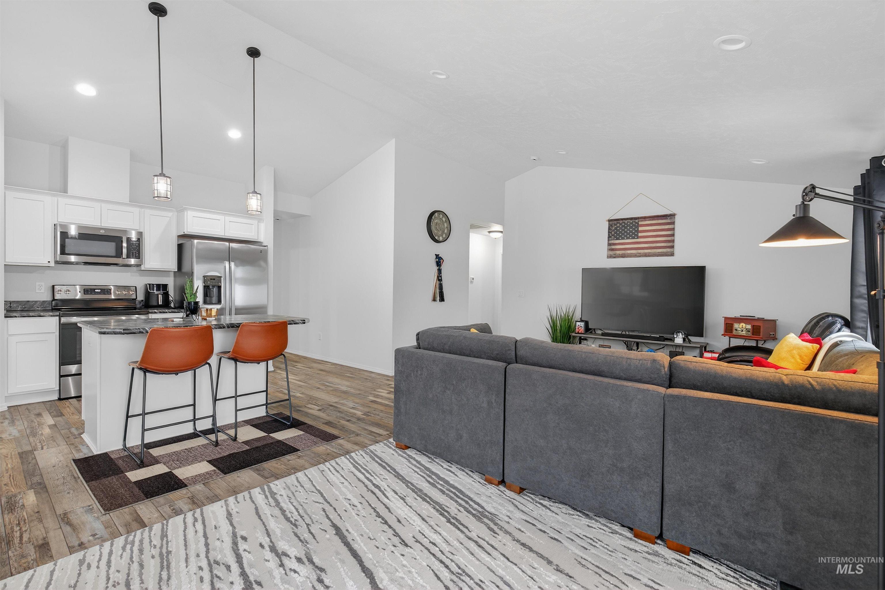 1432 Horizon Court Lewiston, ID 83501 - Photo 9 of 26 Living area with light wood-style flooring, recessed lighting, and high vaulted ceiling