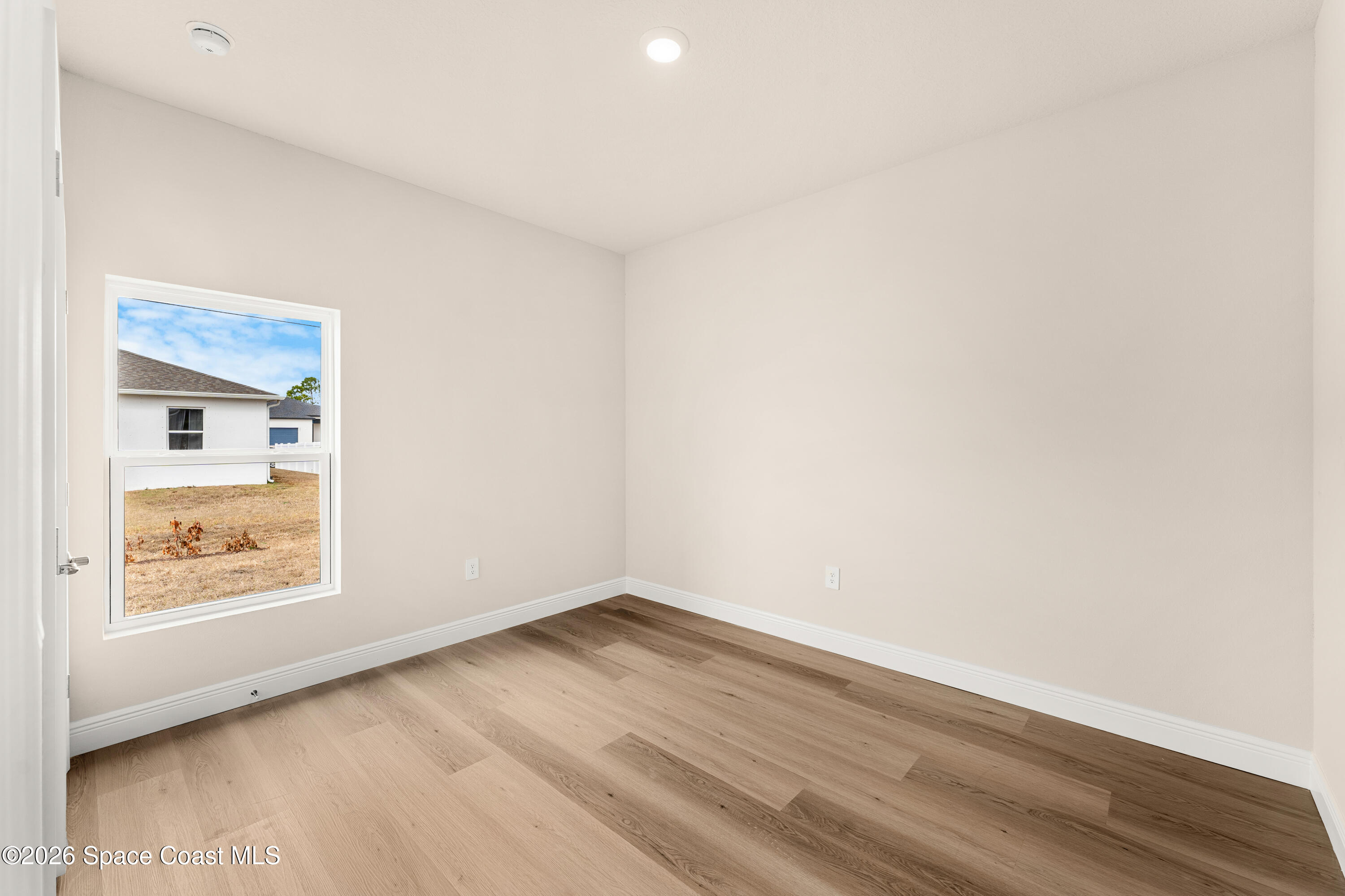 455 Mimosa Street Southwest Palm Bay, FL 32908 - Photo 17 of 43 a view of an empty room and wooden floor