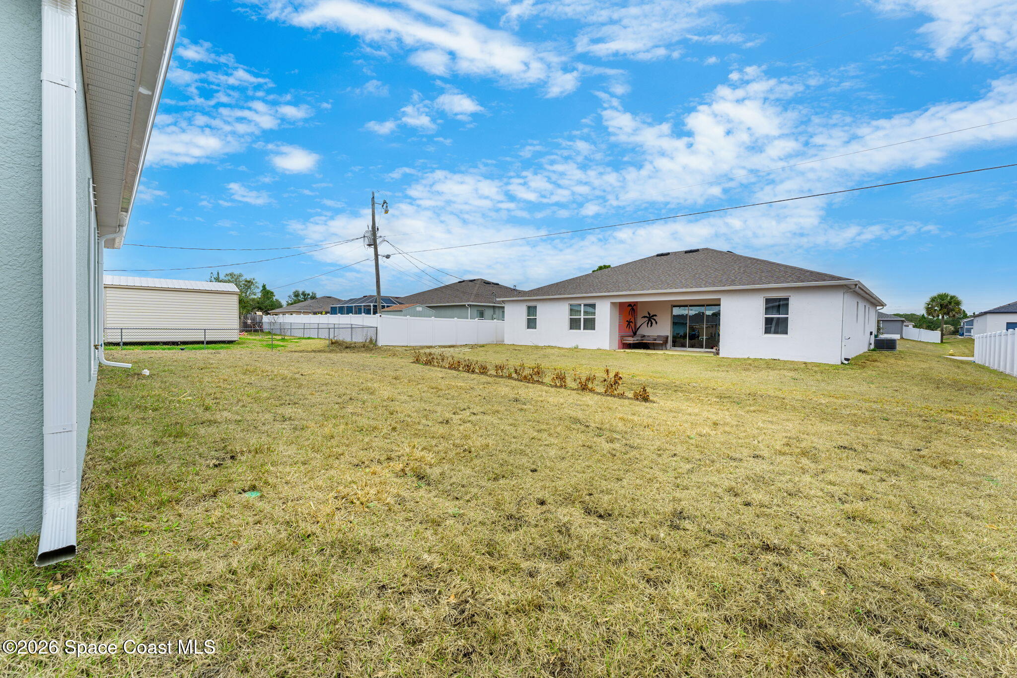 455 Mimosa Street Southwest Palm Bay, FL 32908 - Photo 24 of 43 a front view of a house with a garden