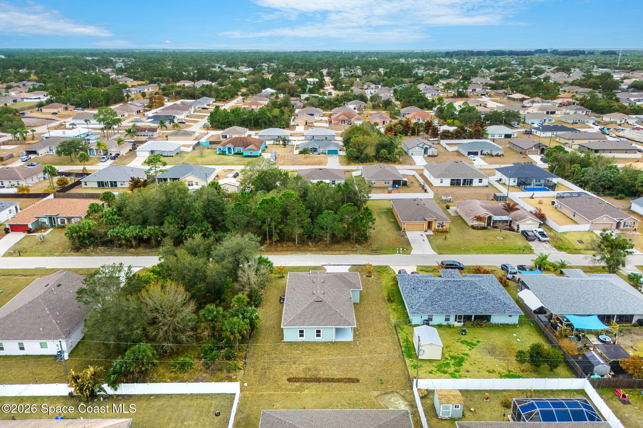 455 Mimosa Street Southwest Palm Bay, FL 32908 - Photo 32 of 43 an aerial view of residential houses with outdoor space and parking