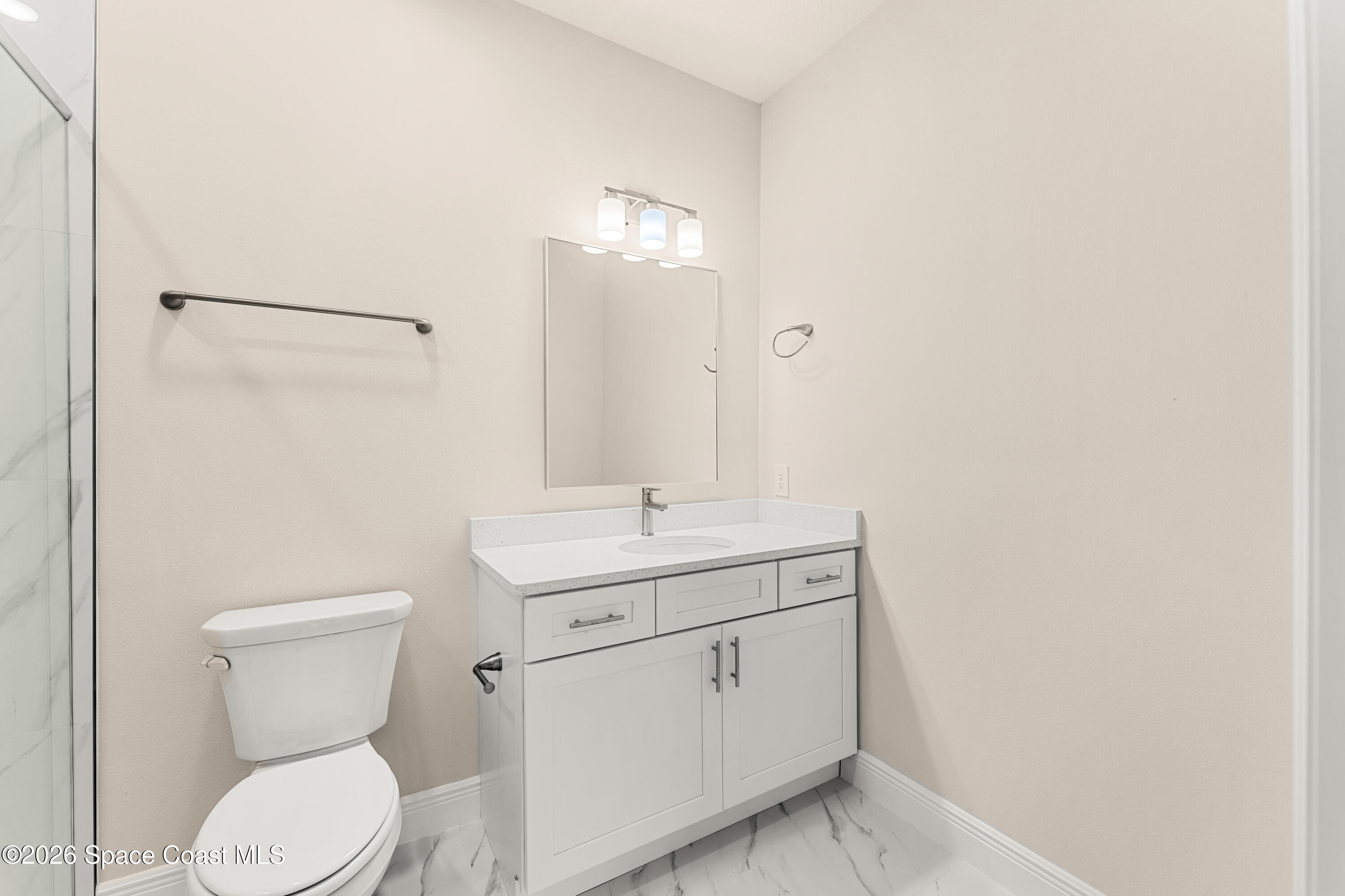 455 Mimosa Street Southwest Palm Bay, FL 32908 - Photo 6 of 43 a bathroom with a toilet a sink and mirror