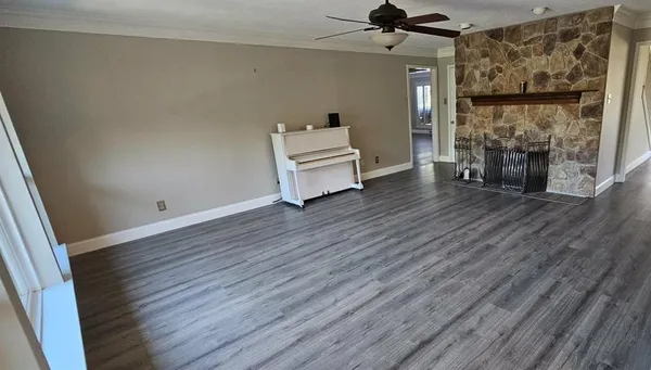 a room with wooden floor and a fireplace