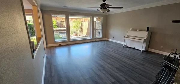 a view of a livingroom with wooden floor and a window