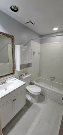 a bathroom with a double vanity sink toilet and shower